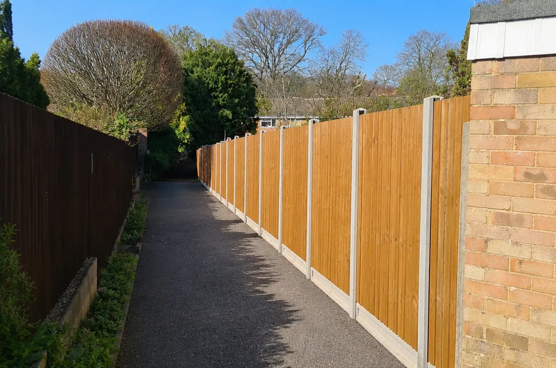 Completed long timber fence run beside a path