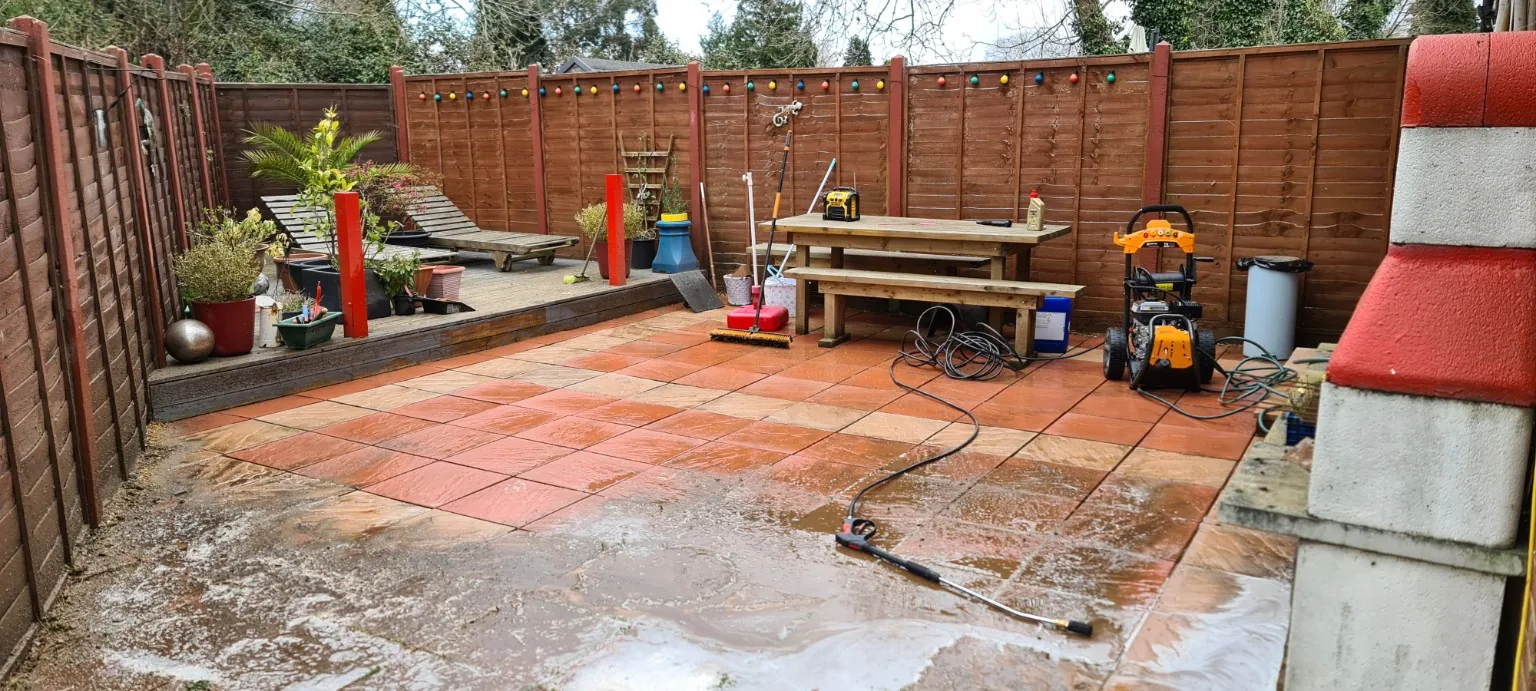 Patio cleaning in progress from the garden side